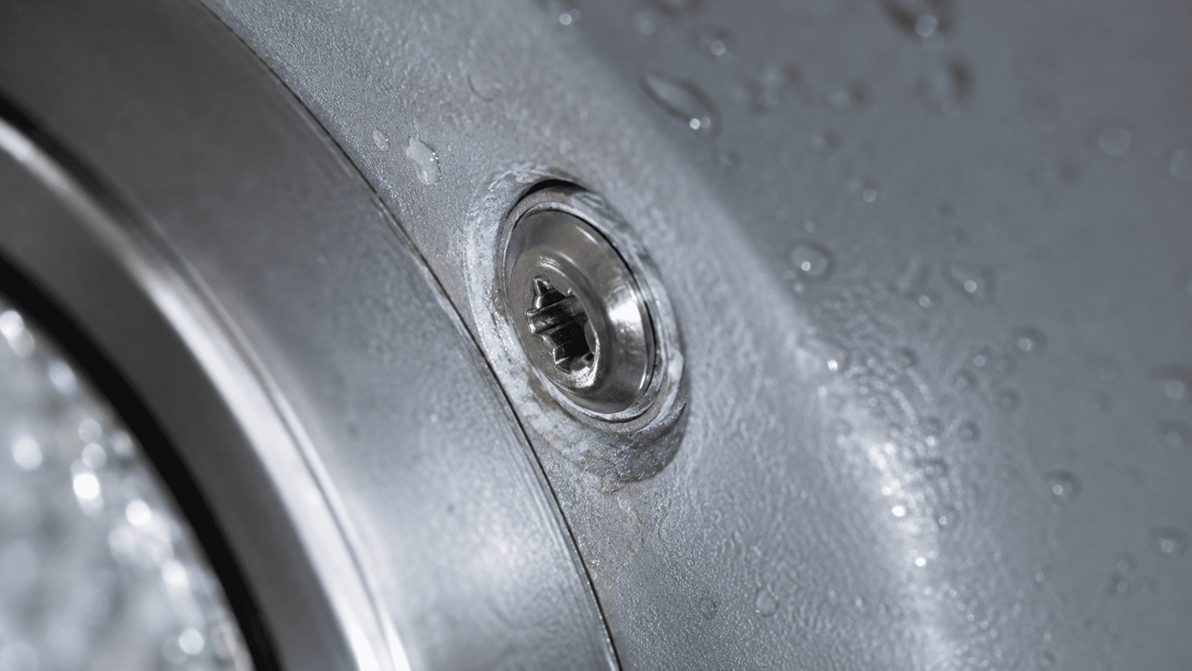 Wet metal fastener interface illustrating a galvanic corrosion risk in an LED housing