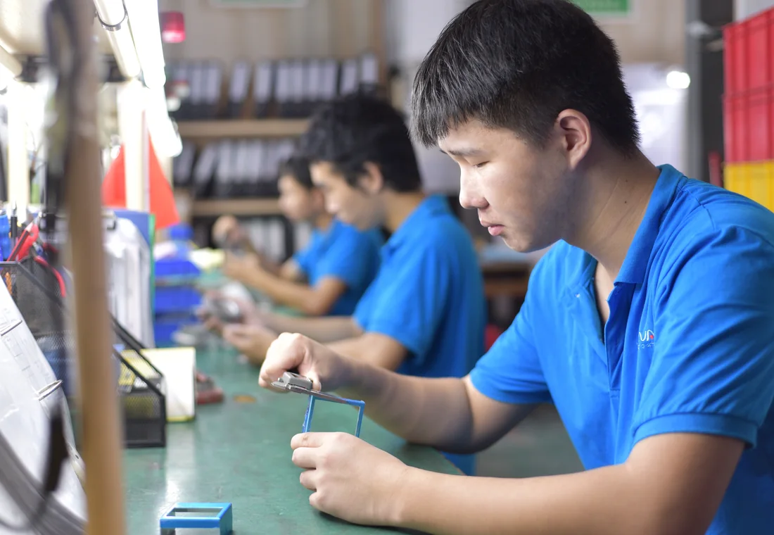 Technicians assembling and checking lighting products at ANOVA
