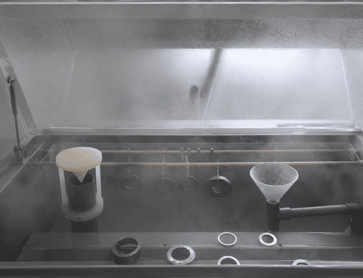 Metal samples undergoing controlled salt-spray exposure